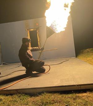A technician demonstrating pyro using a fishtail
